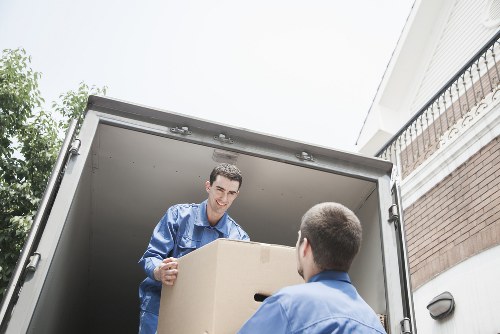 Loading furniture and boxes into a moving van in Edgware