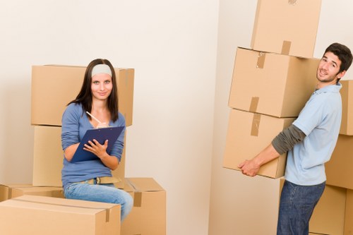 Removal team handling boxes and furniture in Edgware